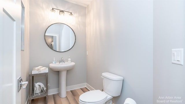 45 Gallery Pointe Dr, Saline, MI 48176 - half bathroom featuring wood finished floors, toilet, a sink, and baseboards