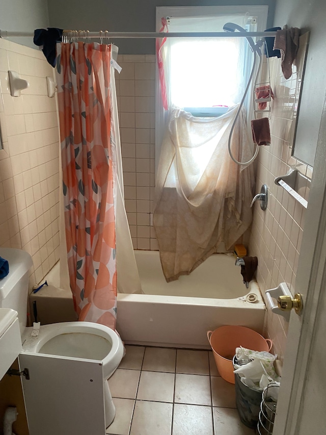 bathroom with tile patterned flooring, shower / bathtub combination with curtain, and tile walls