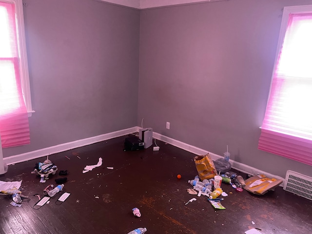 unfurnished room featuring hardwood / wood-style floors and a healthy amount of sunlight