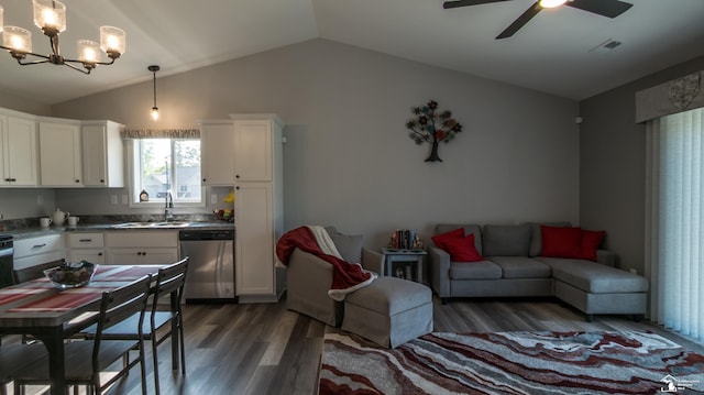 kitchen featuring stainless steel dishwasher, dark wood-type flooring, pendant lighting, white cabinetry, and lofted ceiling