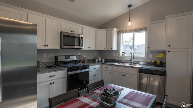 kitchen with white cabinets, stainless steel appliances, vaulted ceiling, and sink