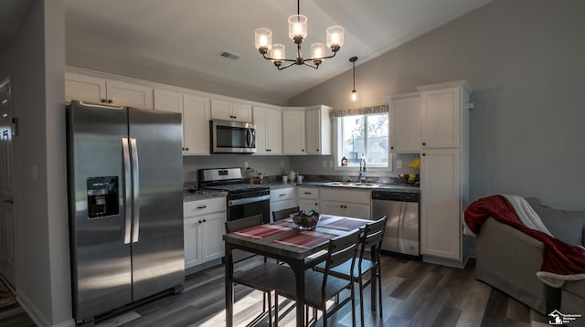 5100 Volterra Dr, Monroe, MI 48161 - kitchen with appliances with stainless steel finishes, lofted ceiling, a chandelier, dark wood-type flooring, and white cabinets