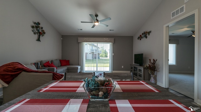 living room featuring ceiling fan, lofted ceiling, and dark colored carpet