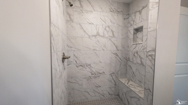 bathroom with a tile shower