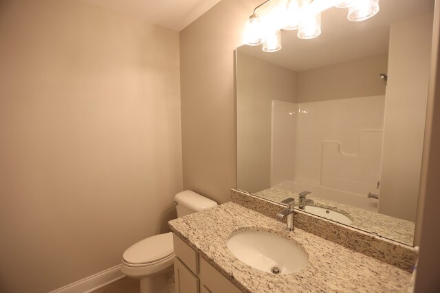 bathroom featuring a shower, vanity, and toilet