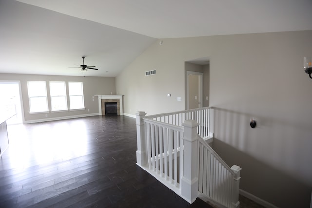 interior space with ceiling fan, dark wood-type flooring, and lofted ceiling