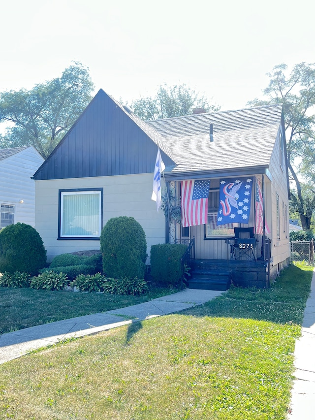 8275 Minock St, Detroit, MI 48228 - bungalow-style home with a front yard and roof with shingles