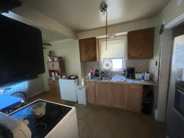 kitchen with white stove, tasteful backsplash, and sink