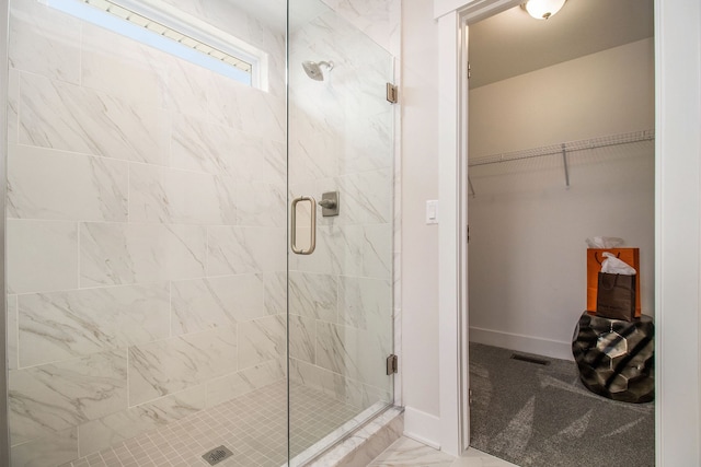 13327 Demil Dr, Romeo, MI 48065 - full bath featuring a shower stall, marble look tile flooring, a walk in closet, and baseboards
