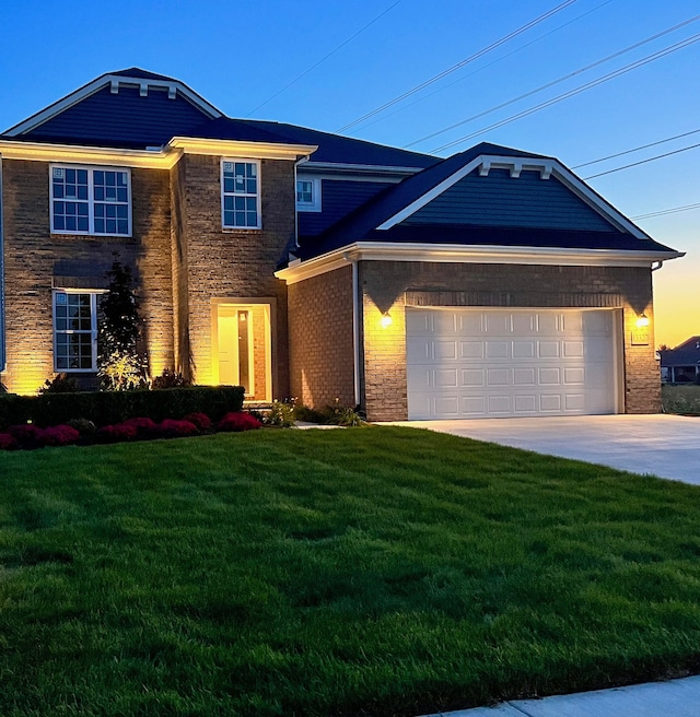 view of front of house featuring a lawn and a garage