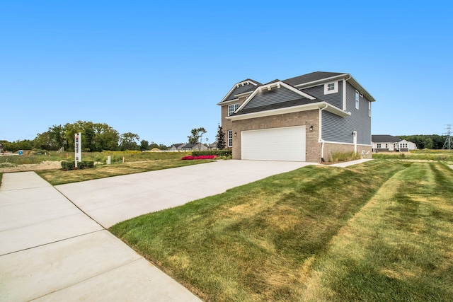 view of front of house featuring a garage and a front lawn