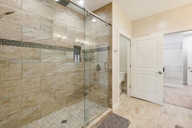 bathroom with toilet and an enclosed shower