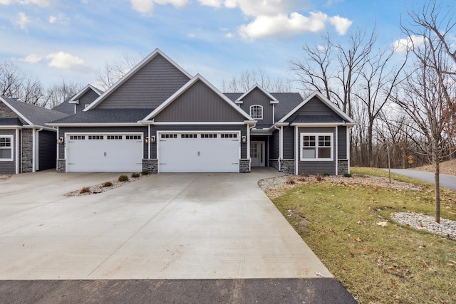 craftsman-style house featuring a garage and a front lawn