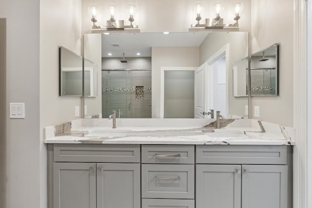 1140 Lochaven Cir Unit 10B, Hillsdale, MI 49242 - bathroom featuring a stall shower and double vanity