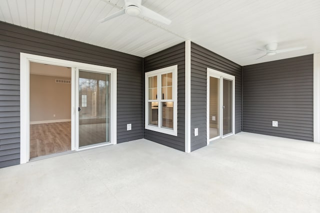 unfurnished sunroom with ceiling fan