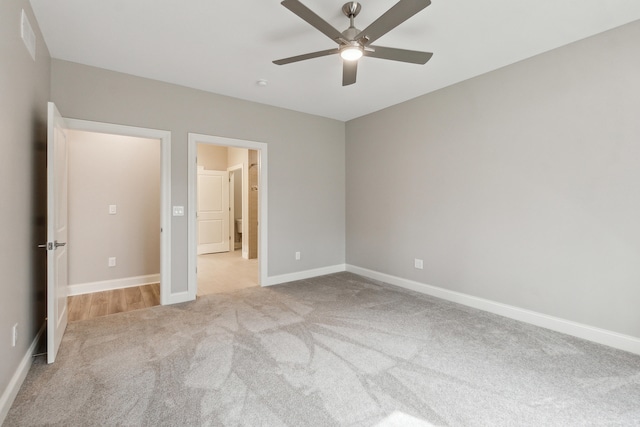 unfurnished bedroom with ceiling fan and light colored carpet