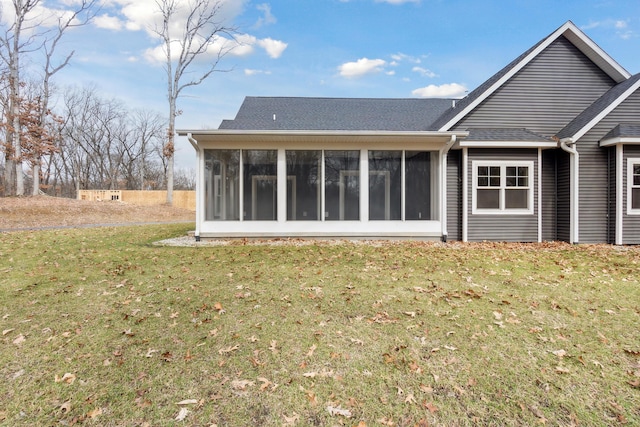 1140 Lochaven Cir Unit 10B, Hillsdale, MI 49242 - rear view of house with a sunroom, a yard, and a shingled roof