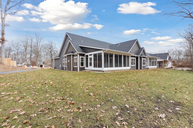 1140 Lochaven Cir Unit 10B, Hillsdale, MI 49242 - back of house featuring a sunroom, a yard, and a shingled roof