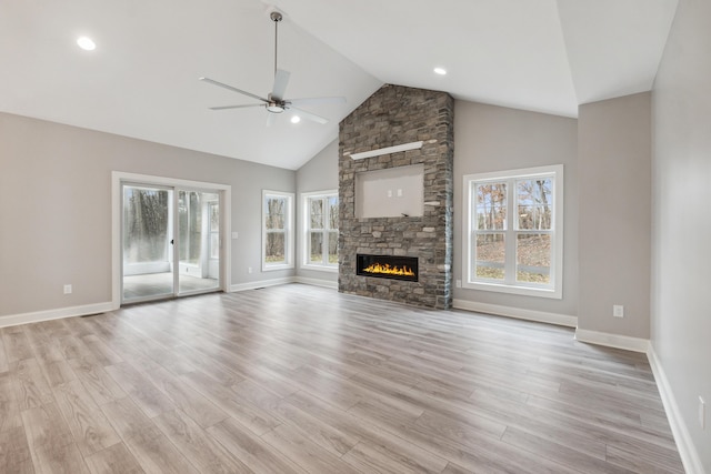 1140 Lochaven Cir Unit 10B, Hillsdale, MI 49242 - unfurnished living room with a ceiling fan, plenty of natural light, light wood-style flooring, baseboards, and high vaulted ceiling