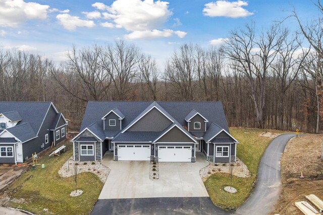 1140 Lochaven Cir Unit 10B, Hillsdale, MI 49242 - view of front of house featuring driveway, a garage, and a front lawn