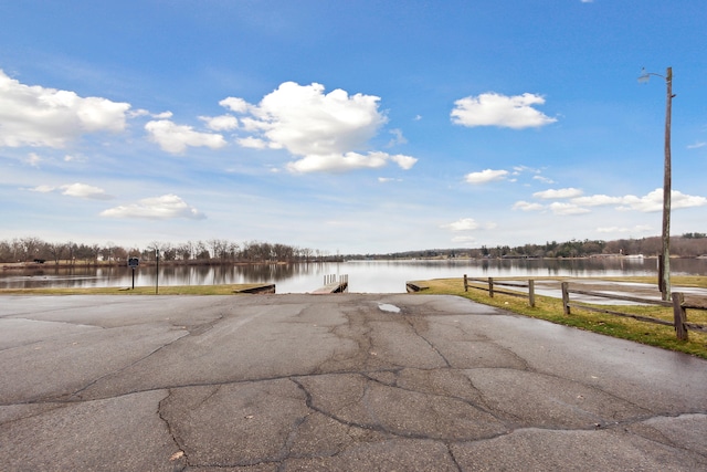 exterior space featuring a water view and a dock