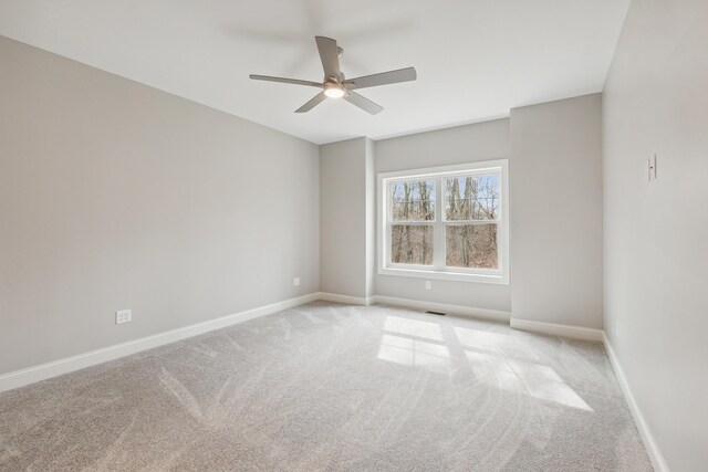 1140 Lochaven Cir Unit 10B, Hillsdale, MI 49242 - spare room with carpet, a ceiling fan, and baseboards