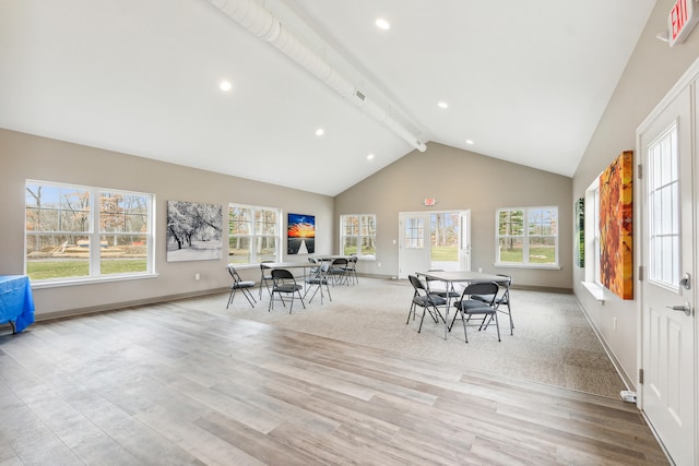 dining area featuring beamed ceiling, plenty of natural light, high vaulted ceiling, and light hardwood / wood-style flooring