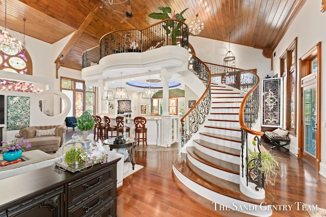 living room featuring a chandelier, hardwood / wood-style floors, a high ceiling, and wood ceiling