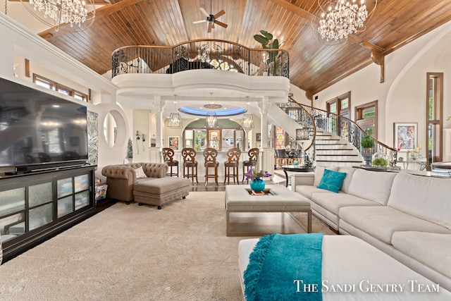 carpeted living room featuring ceiling fan, wood ceiling, and a towering ceiling