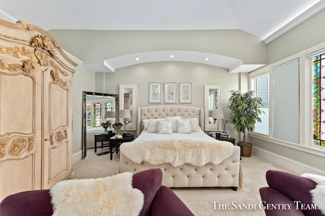 carpeted bedroom with vaulted ceiling