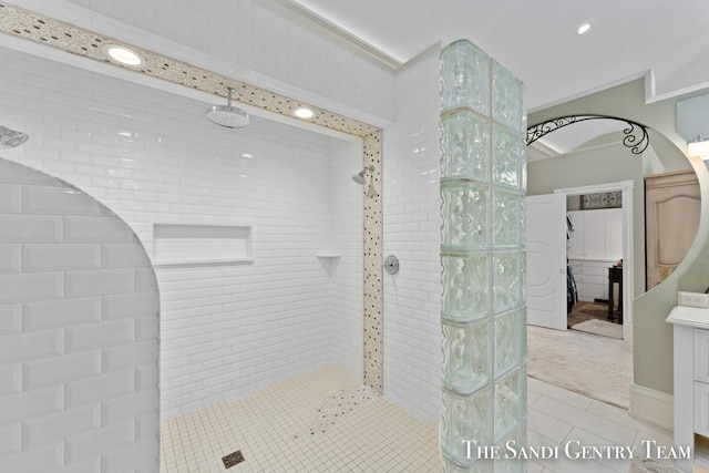 bathroom with tile patterned floors and tiled shower