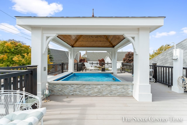 view of swimming pool featuring a gazebo and a deck