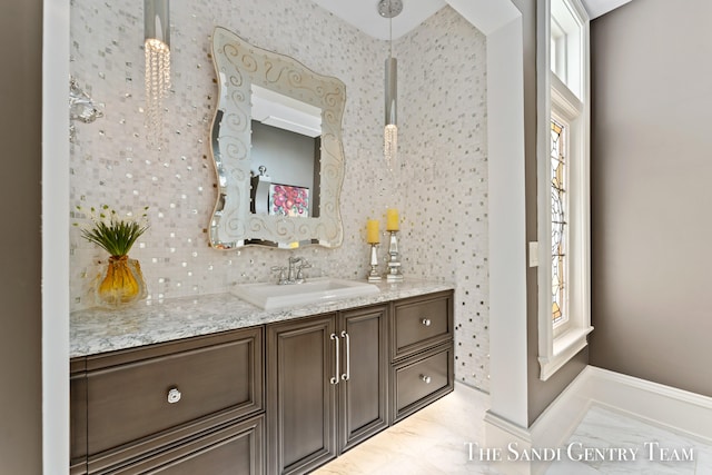 bathroom with vanity and decorative backsplash