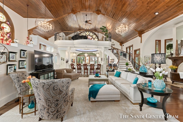 living room with ceiling fan with notable chandelier, light hardwood / wood-style floors, high vaulted ceiling, and wooden ceiling