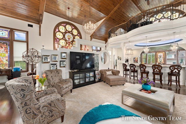 living room with wood-type flooring, high vaulted ceiling, beam ceiling, and wood ceiling