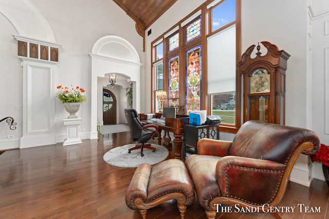 living area featuring high vaulted ceiling, dark wood-type flooring, and wood ceiling