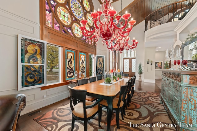 dining room with a wealth of natural light, a high ceiling, and an inviting chandelier