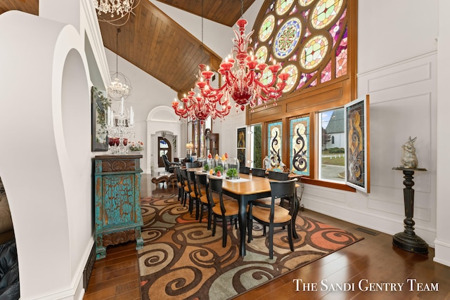 dining area with wood ceiling, high vaulted ceiling, dark wood-type flooring, and a notable chandelier