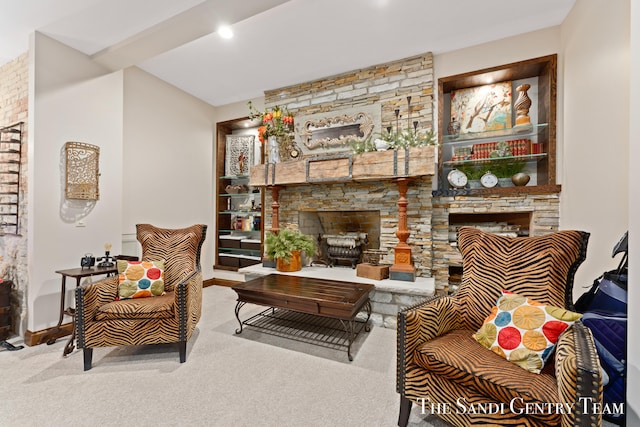 living room featuring carpet flooring and a stone fireplace