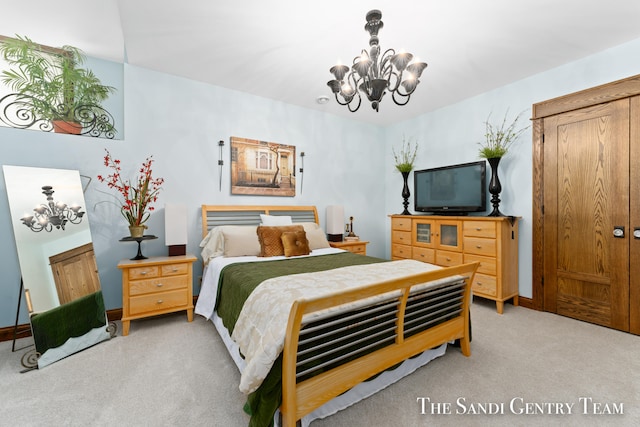 bedroom with light carpet and a notable chandelier