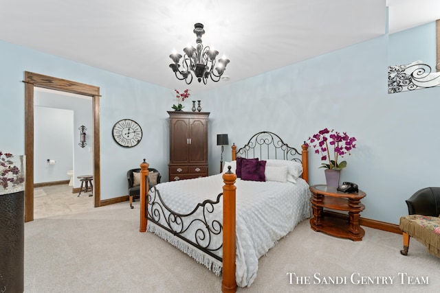 carpeted bedroom featuring an inviting chandelier