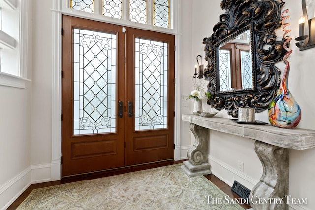 foyer featuring light hardwood / wood-style flooring and french doors