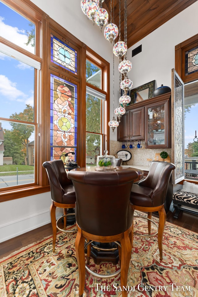 dining space with plenty of natural light and wood-type flooring