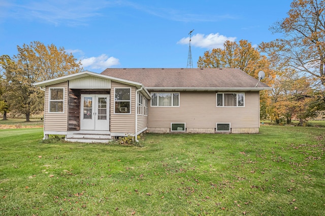 rear view of property featuring a yard