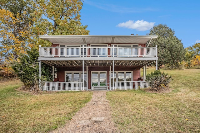 view of front of house featuring a front lawn and a deck