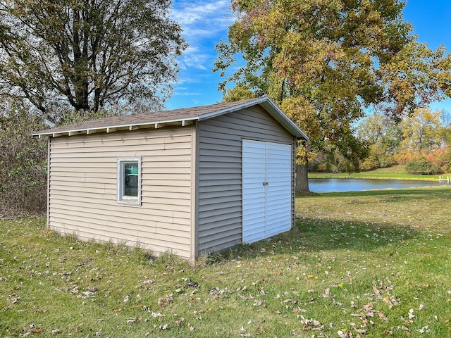 view of outbuilding featuring a yard and a water view