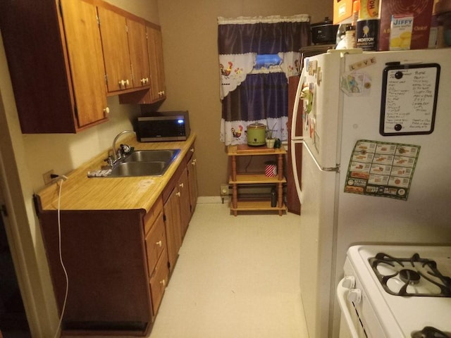 kitchen featuring white appliances and sink