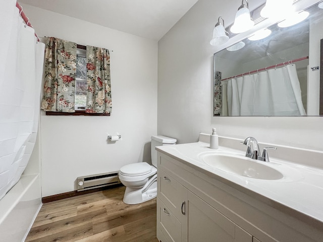 full bathroom featuring a baseboard radiator, hardwood / wood-style floors, toilet, vanity, and shower / tub combo