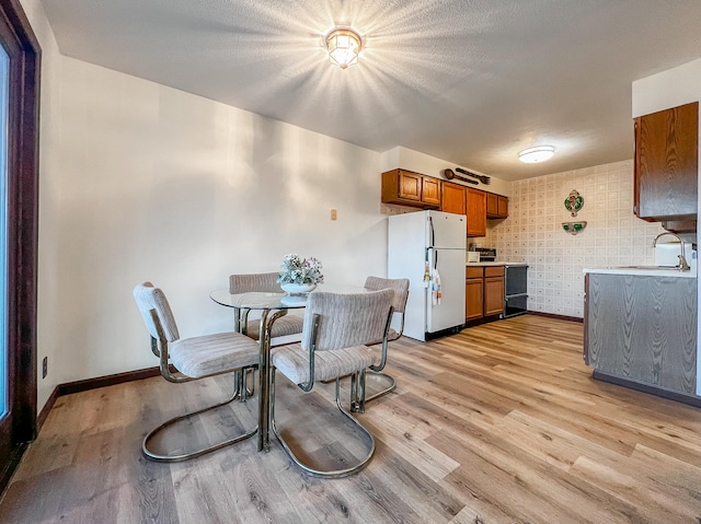 dining room featuring light hardwood / wood-style flooring and sink