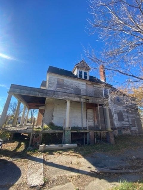100 Pingree St, Detroit, MI 48202 - rear view of property with a chimney and covered porch